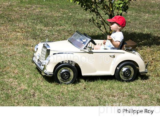 PETIT GARCON DE DIX-SEPT  MOIS   DANS UNE VOITURE POUR ENFANT (00P02709.jpg)